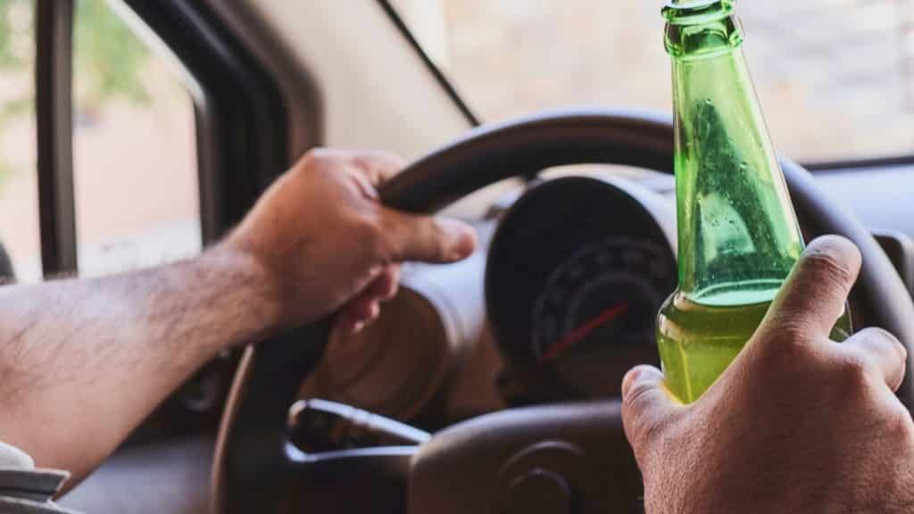 Driver of vehicle holding beer